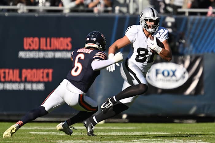 Oct 22, 2023; Chicago, Illinois, USA; Las Vegas Raiders tight end Austin Hooper (81) runs upfield with the ball after a reception as Chicago Bears defensive back Kyler Gordon (6) closes in for the tackle in the fourth quarter at Soldier Field. Mandatory Credit: Jamie Sabau-USA TODAY Sports
